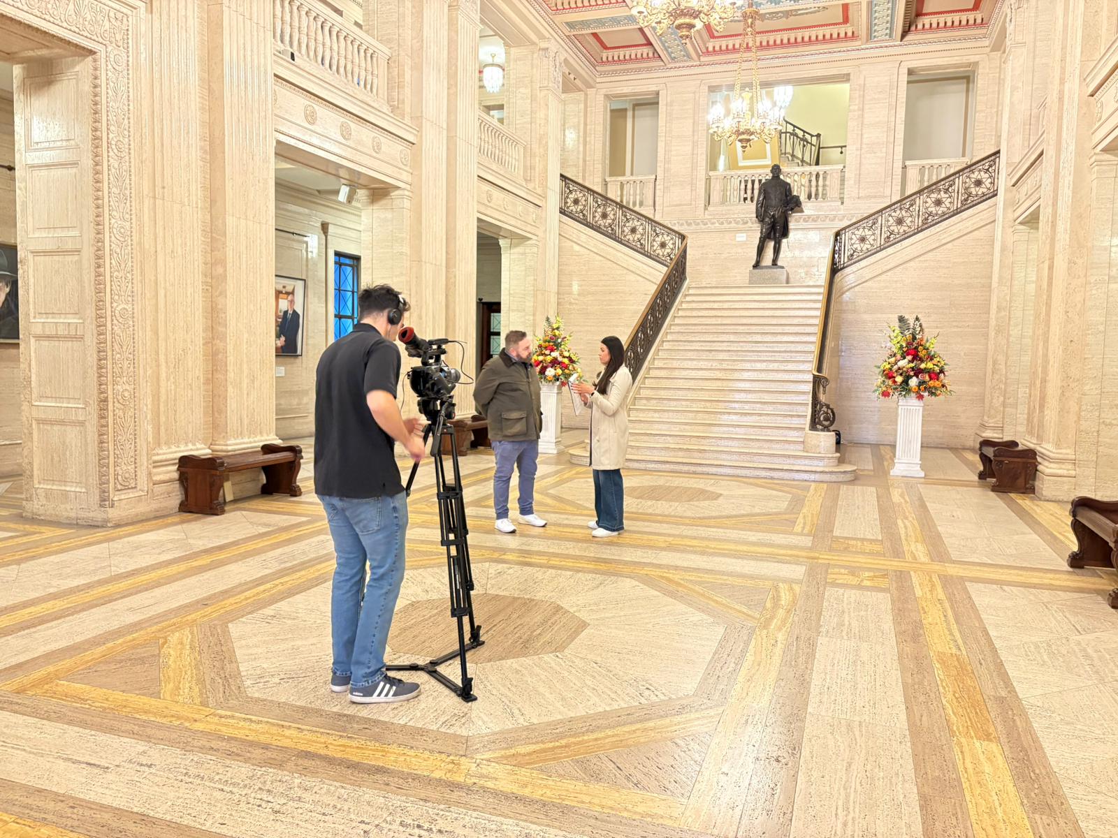 The SlackPress team preparing a presenter and camera in the entrance hall at Parliament Buildings, Stormont.
