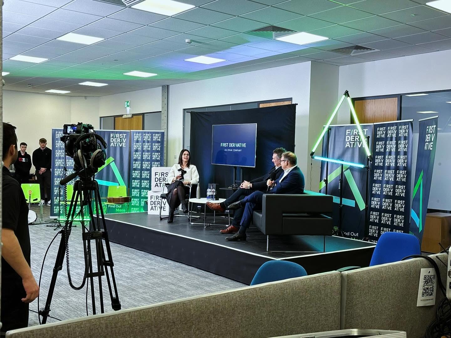 Cameras set up around a stage for a First Derivative panel discussion.
